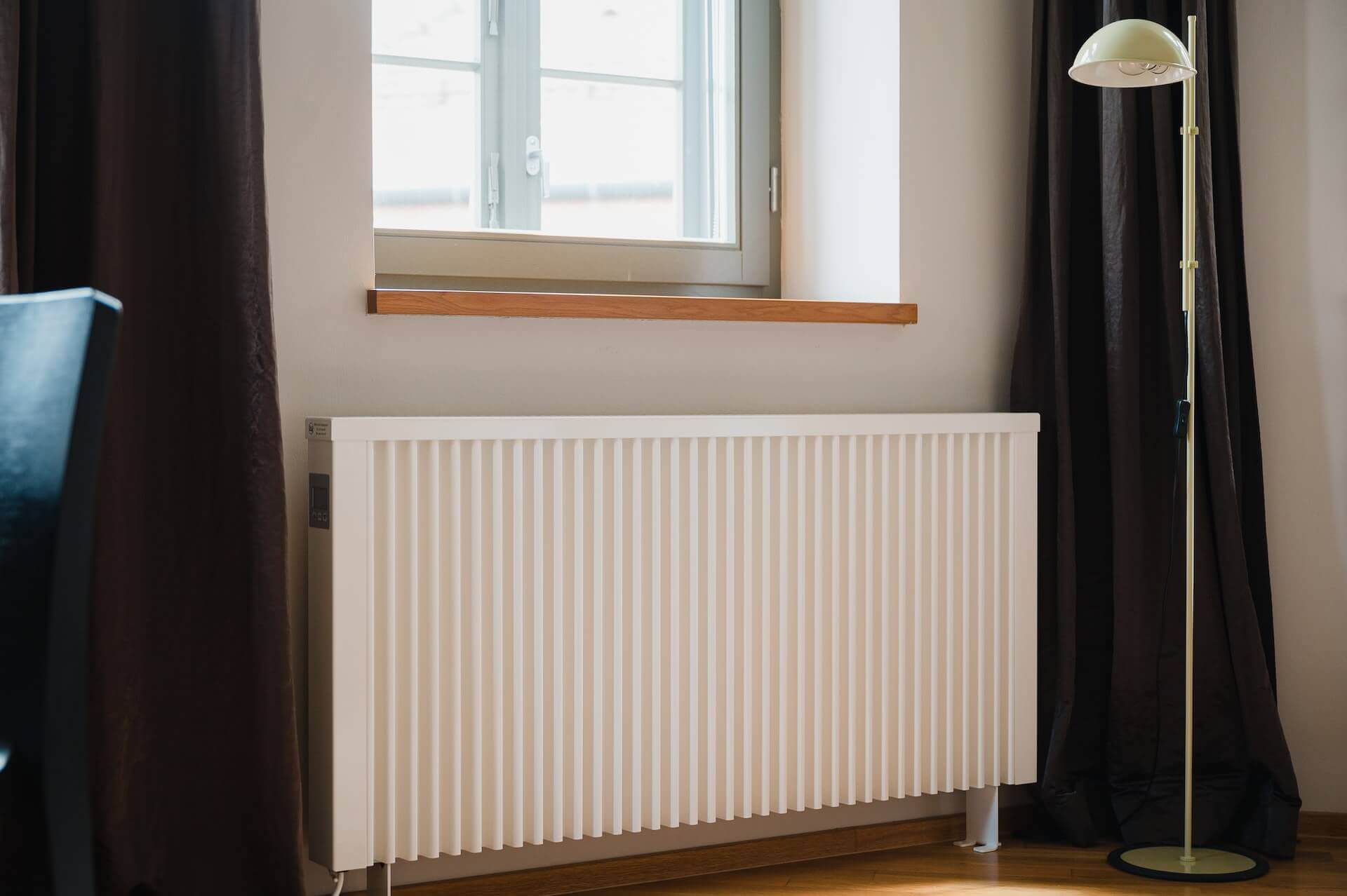 radiator under the window with curtains